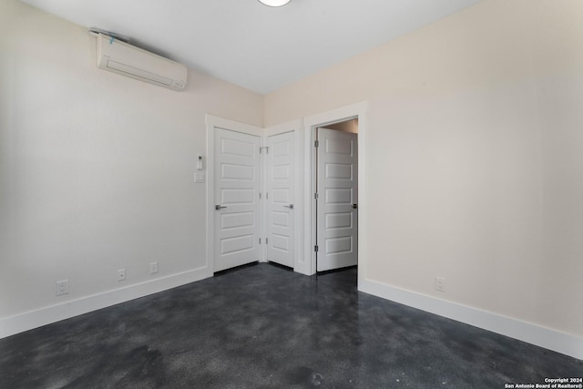 unfurnished bedroom featuring a wall unit AC