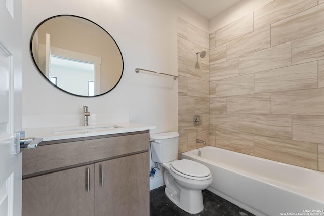 full bathroom featuring tiled shower / bath combo, toilet, and vanity