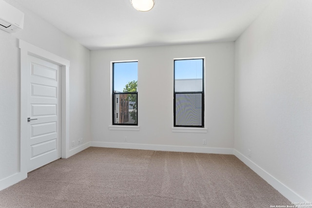 unfurnished room featuring an AC wall unit and light colored carpet