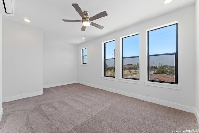 carpeted spare room with ceiling fan