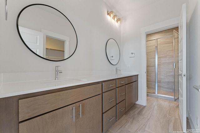 bathroom with vanity and a shower with door