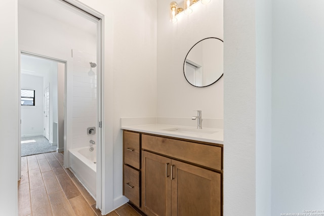 bathroom with vanity, bathing tub / shower combination, and hardwood / wood-style floors