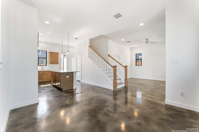 living room with ceiling fan and sink