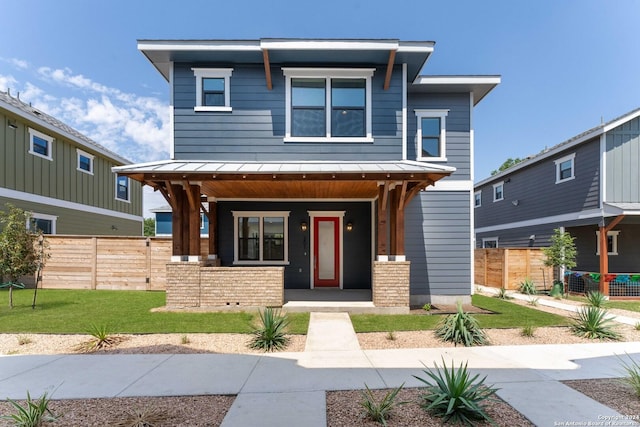 view of front of property featuring covered porch and a front yard