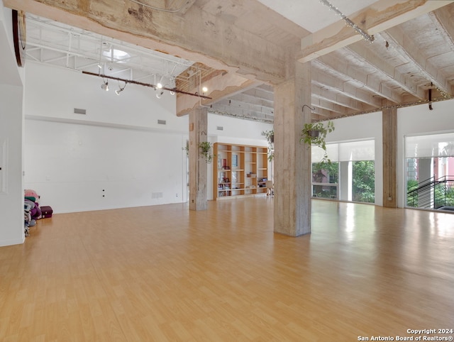 empty room with a high ceiling and hardwood / wood-style floors