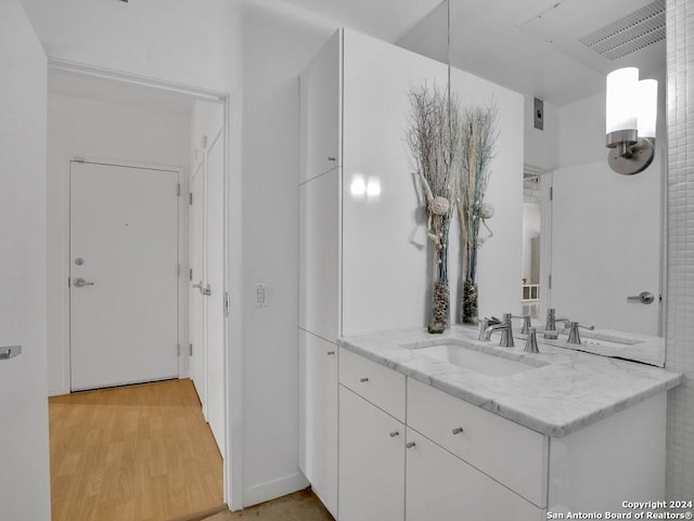 bathroom with vanity and hardwood / wood-style flooring