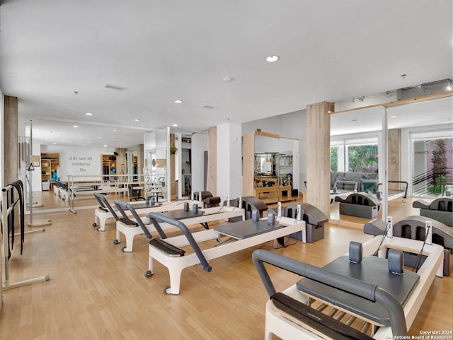 exercise room with light wood-type flooring