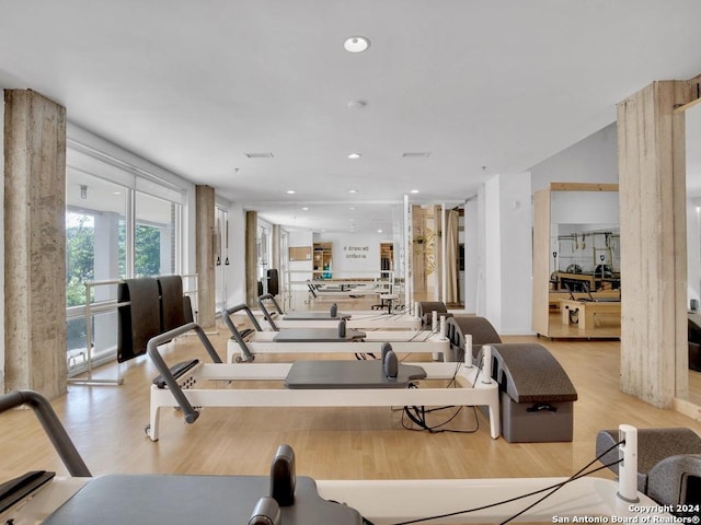 exercise room featuring light wood-type flooring