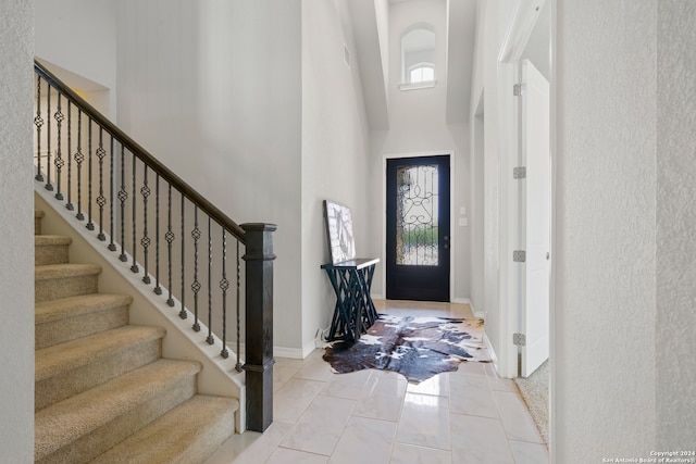 tiled entryway with a high ceiling