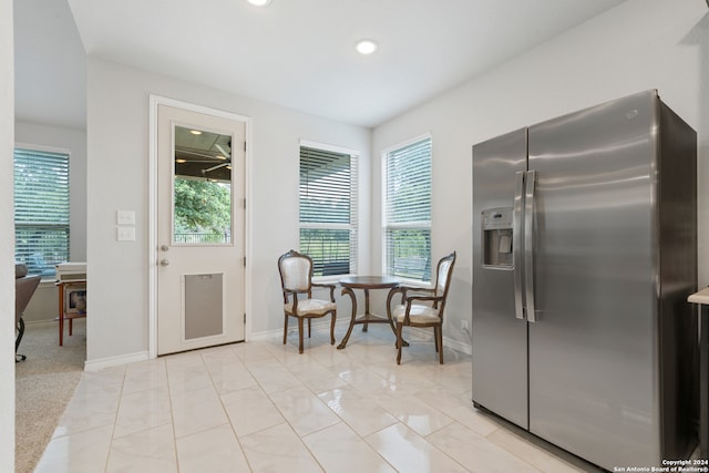 kitchen with stainless steel fridge with ice dispenser and light tile patterned floors