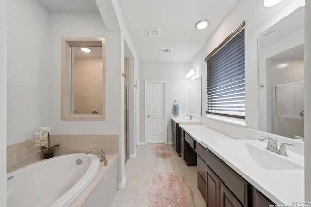 bathroom with tile patterned flooring, vanity, and separate shower and tub