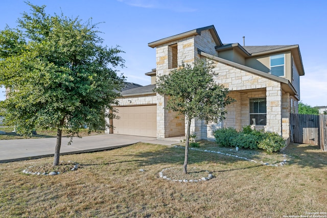 view of front of home featuring a garage and a front yard