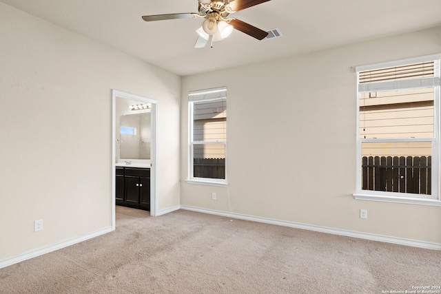 carpeted spare room with ceiling fan