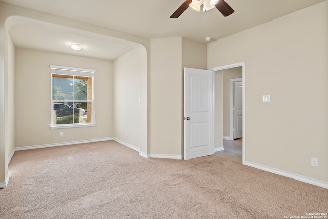 carpeted empty room featuring ceiling fan