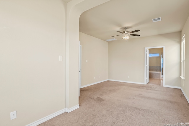 carpeted spare room featuring ceiling fan