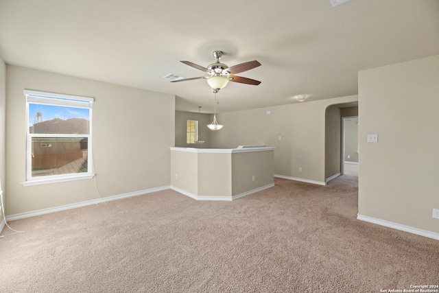 spare room featuring ceiling fan and carpet floors