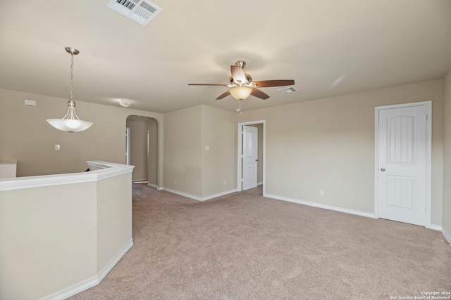 carpeted empty room featuring ceiling fan