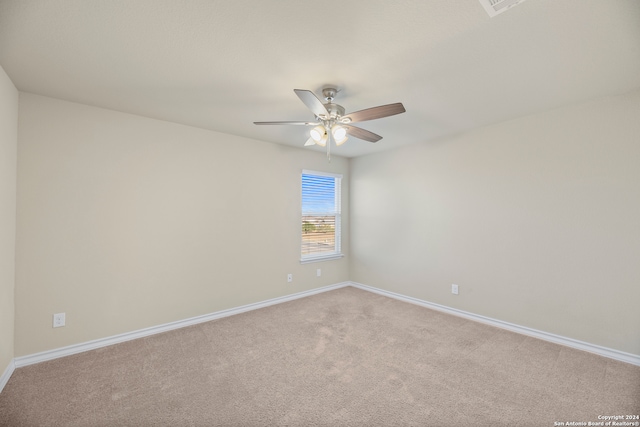 carpeted spare room with ceiling fan