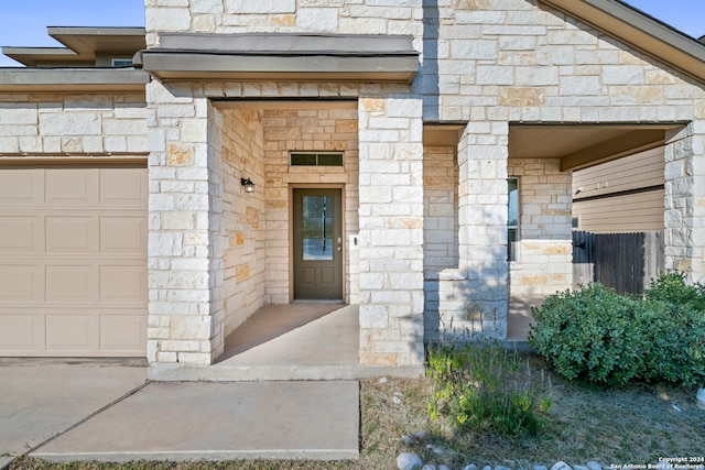 view of exterior entry with a garage