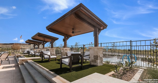 view of patio / terrace featuring ceiling fan, a water view, and an outdoor hangout area