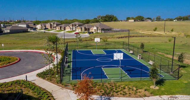 view of sport court featuring a yard