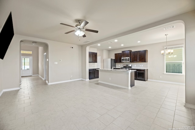 unfurnished living room featuring ceiling fan with notable chandelier and light tile patterned floors