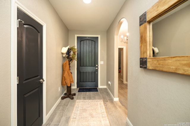 foyer entrance featuring a notable chandelier and hardwood / wood-style flooring