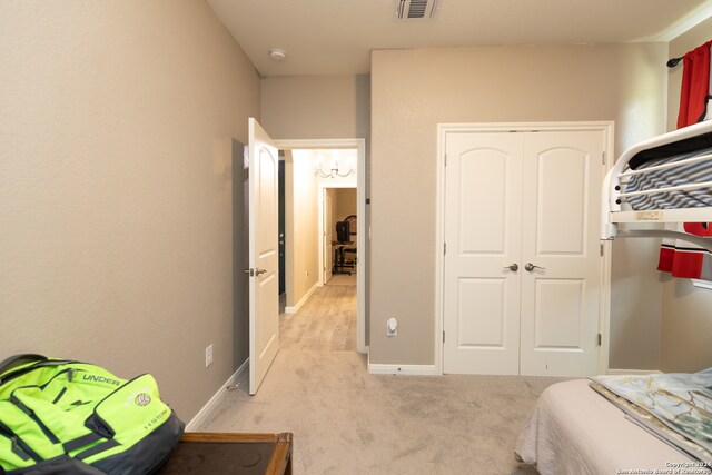 bedroom featuring a closet and light colored carpet