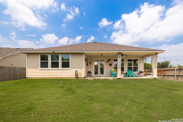 back of house featuring a patio area, a lawn, and ceiling fan