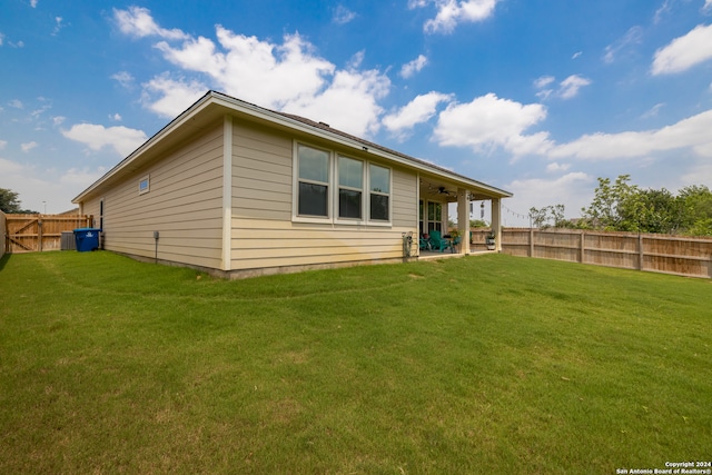 back of house with a yard