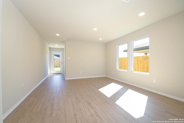 empty room featuring a wealth of natural light and light hardwood / wood-style floors