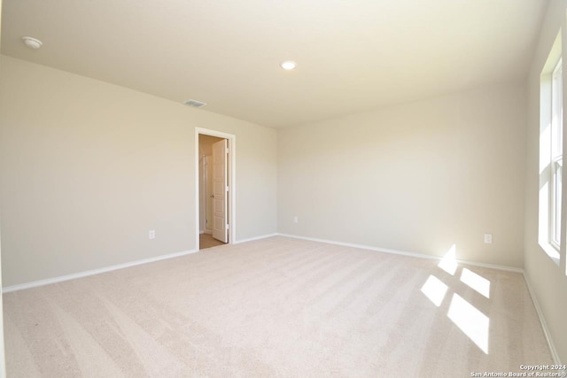 unfurnished room featuring light colored carpet