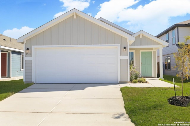 view of front of property with a garage and a front yard