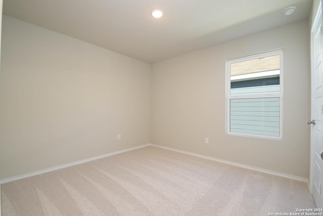 unfurnished room with light colored carpet