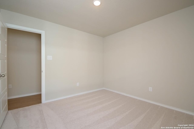 unfurnished room with light carpet