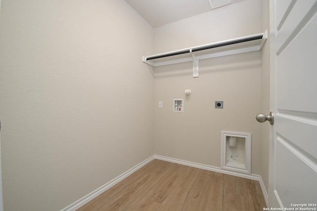 washroom with electric dryer hookup, hookup for a gas dryer, wood-type flooring, and washer hookup