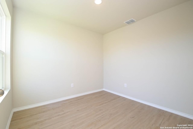 unfurnished room with light hardwood / wood-style floors