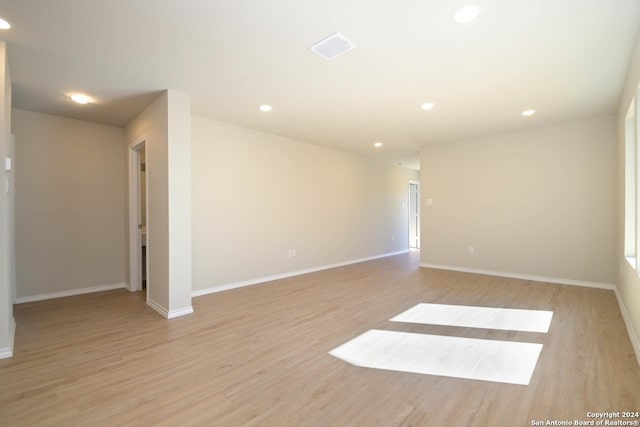 unfurnished room with light wood-type flooring