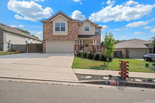 view of property featuring a front lawn and a garage