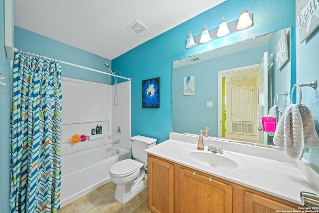 full bathroom with vanity, toilet, tile floors, and shower / bath combo