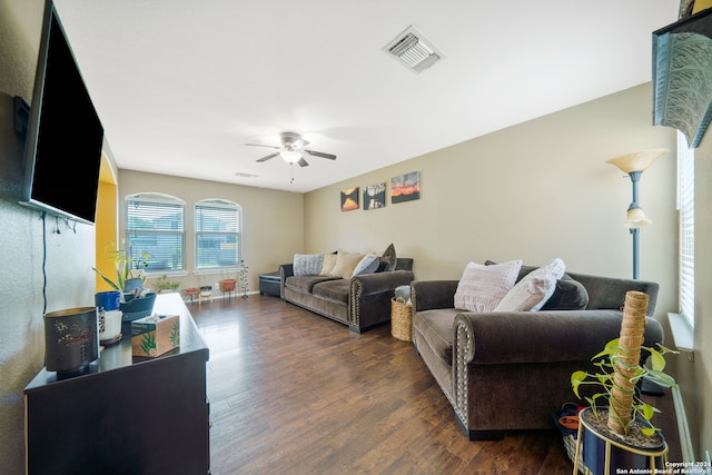 living room with ceiling fan and dark hardwood / wood-style floors