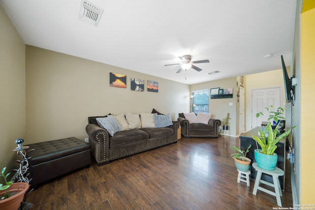 living room featuring ceiling fan and dark hardwood / wood-style flooring