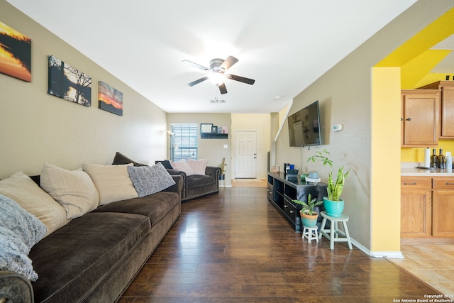 living room with dark hardwood / wood-style floors and ceiling fan