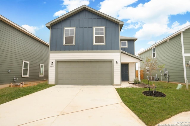 view of front of property with a garage and a front lawn