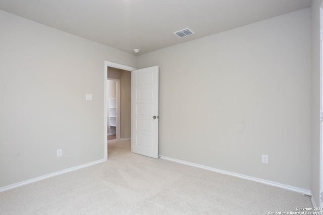 unfurnished bedroom featuring carpet and a closet