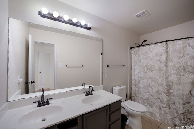 bathroom featuring tile patterned floors, vanity, and toilet