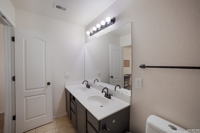 bathroom featuring tile patterned floors, vanity, and toilet