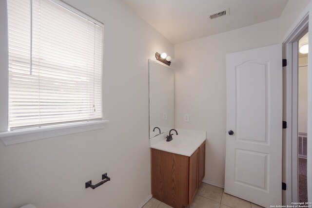 bathroom with tile patterned flooring and vanity