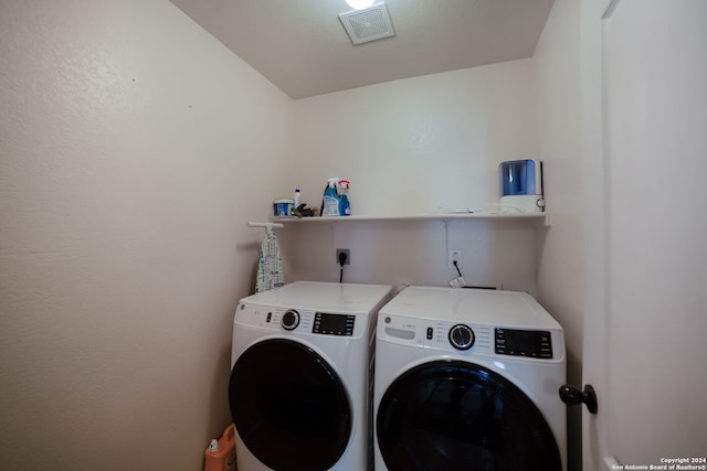 laundry room featuring separate washer and dryer