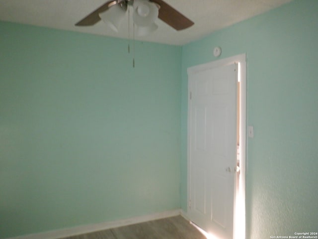 unfurnished room with hardwood / wood-style flooring and ceiling fan